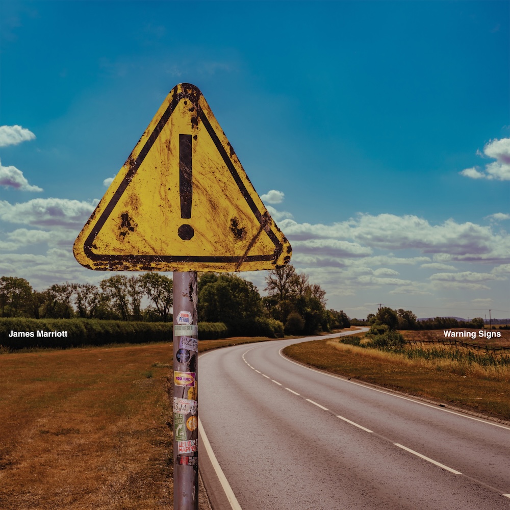 Album cover for James Marriott's Warning Signs featuring a weathered yellow exclamation road sign beside a winding rural highway.